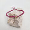 pulsera estrella malva, hecha a mano con poliéster encerado y una pieza central con baño de oro.